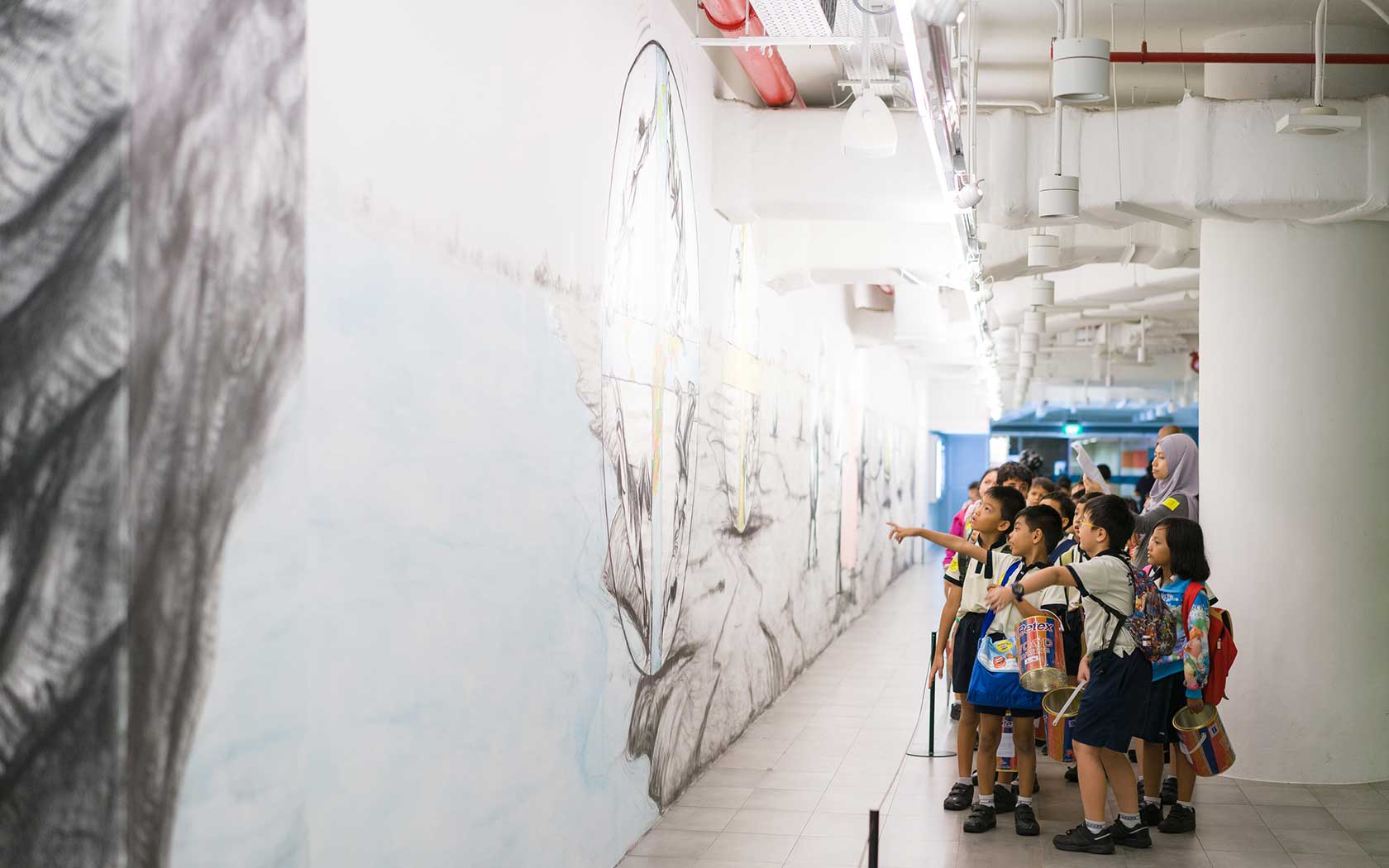 Students with a teacher at Esplanade Tunnel looking at a mural.