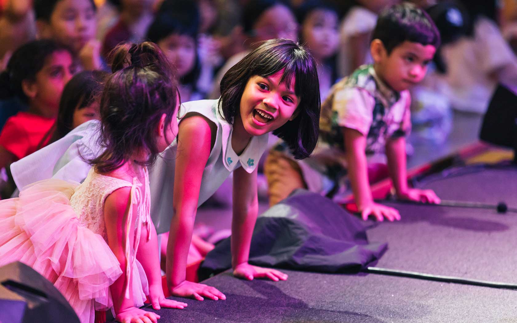 Image of children having fun near the stage during a performance