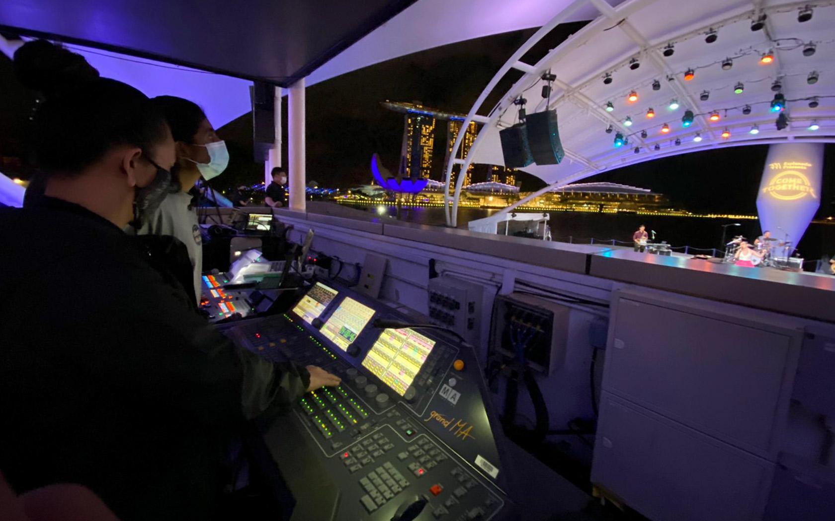 An image of a lady operating the lighting controls at Esplanade Outdoor Theatre.