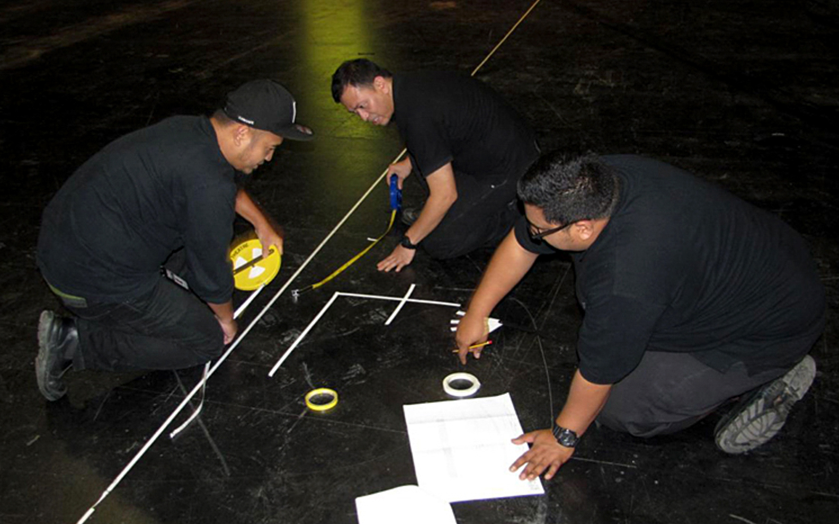 An image of three men marking the stage