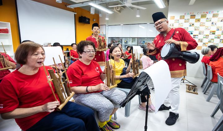 Seniors learning a musical instrument in an Esplanade community engagement workshop