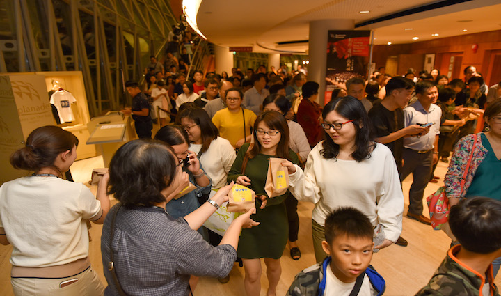 Audiences receiving samples of an Esplanade sponsor’s product after a show.
