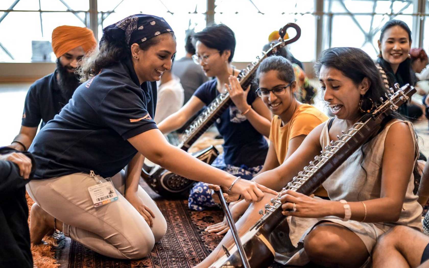 Image depicting participants and instructors at a workshop featuring instruments used in Sikh traditions