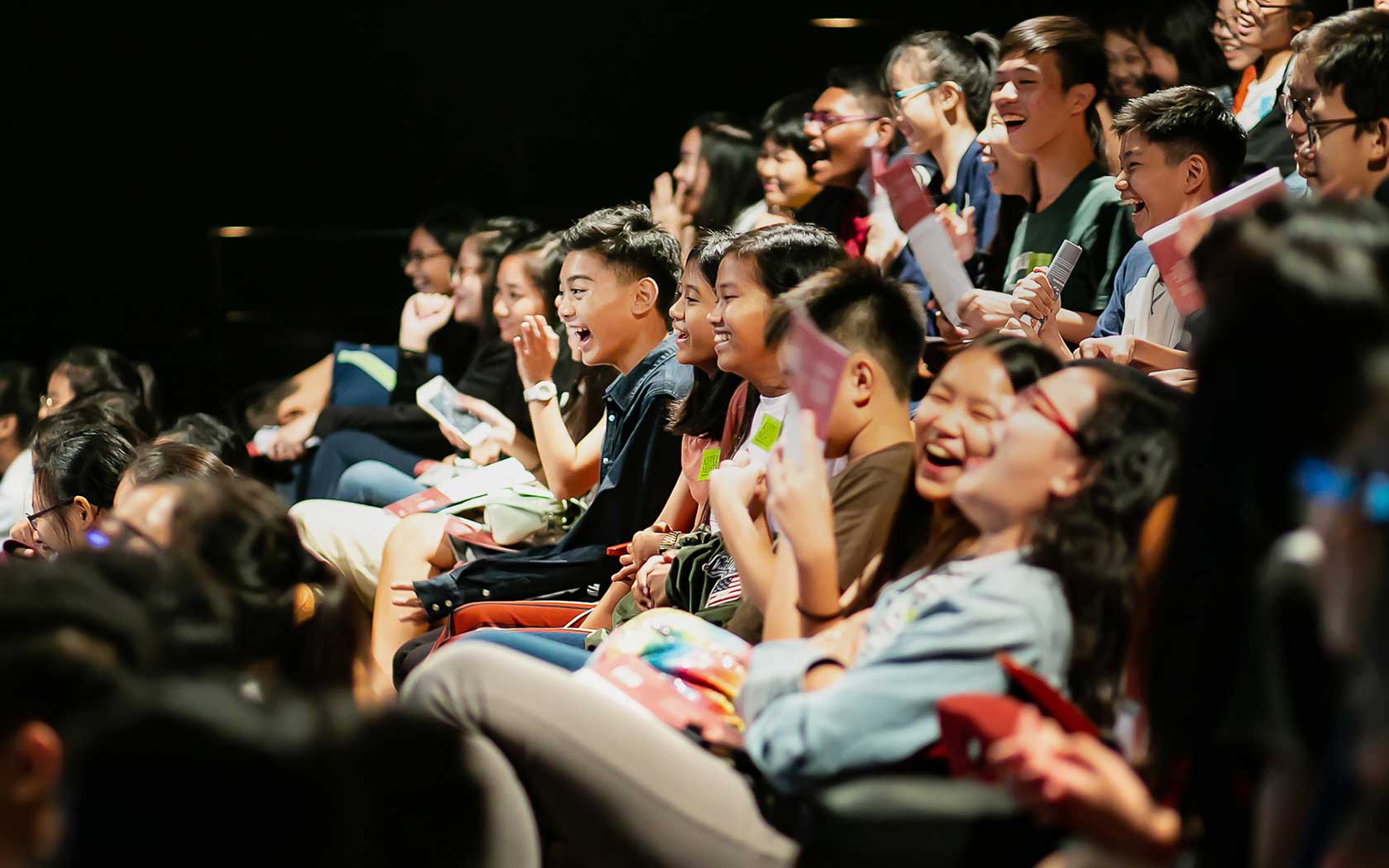 Image depicting students in the audience enjoying a performance at Esplanade.