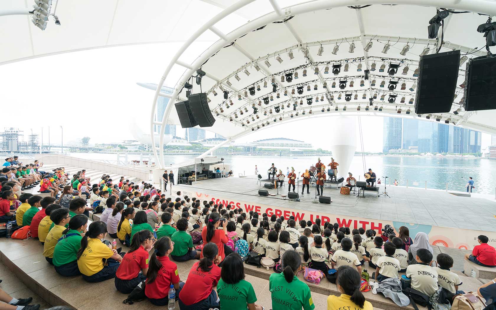 Students watching a performance at Esplanade Outdoor Theatre.