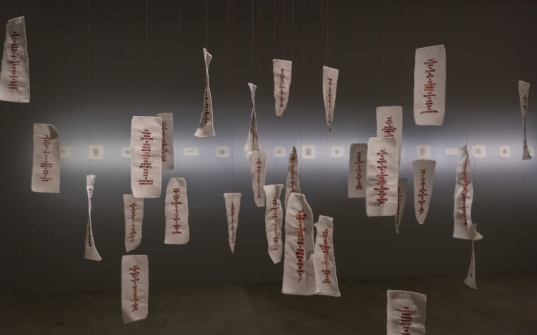 Installation view of Talismans for Disentanglement (2021), in the exhibition Sewing Discord. Pearl cotton thread on unbleached calico. Image courtesy of Esplanade - Theatres on the Bay. Photo by Ken Cheong.