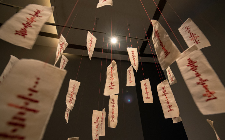 Installation view of Talismans of Disentanglement (2021), in the exhibition Sewing Discord. Pearl cotton thread on unbleached calico. Image courtesy of Esplanade - Theatres on the Bay. Photo by See Kian Wee.