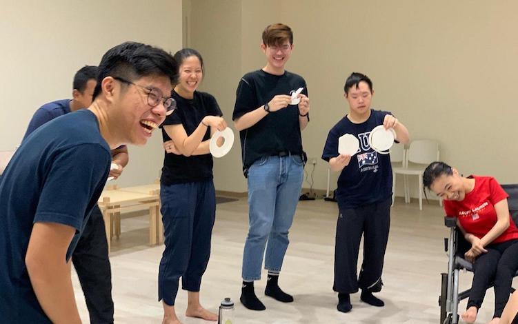 During an exercise as part of the devising process, the team of What If split into groups and used paper plates to create a logo for an imaginary company.