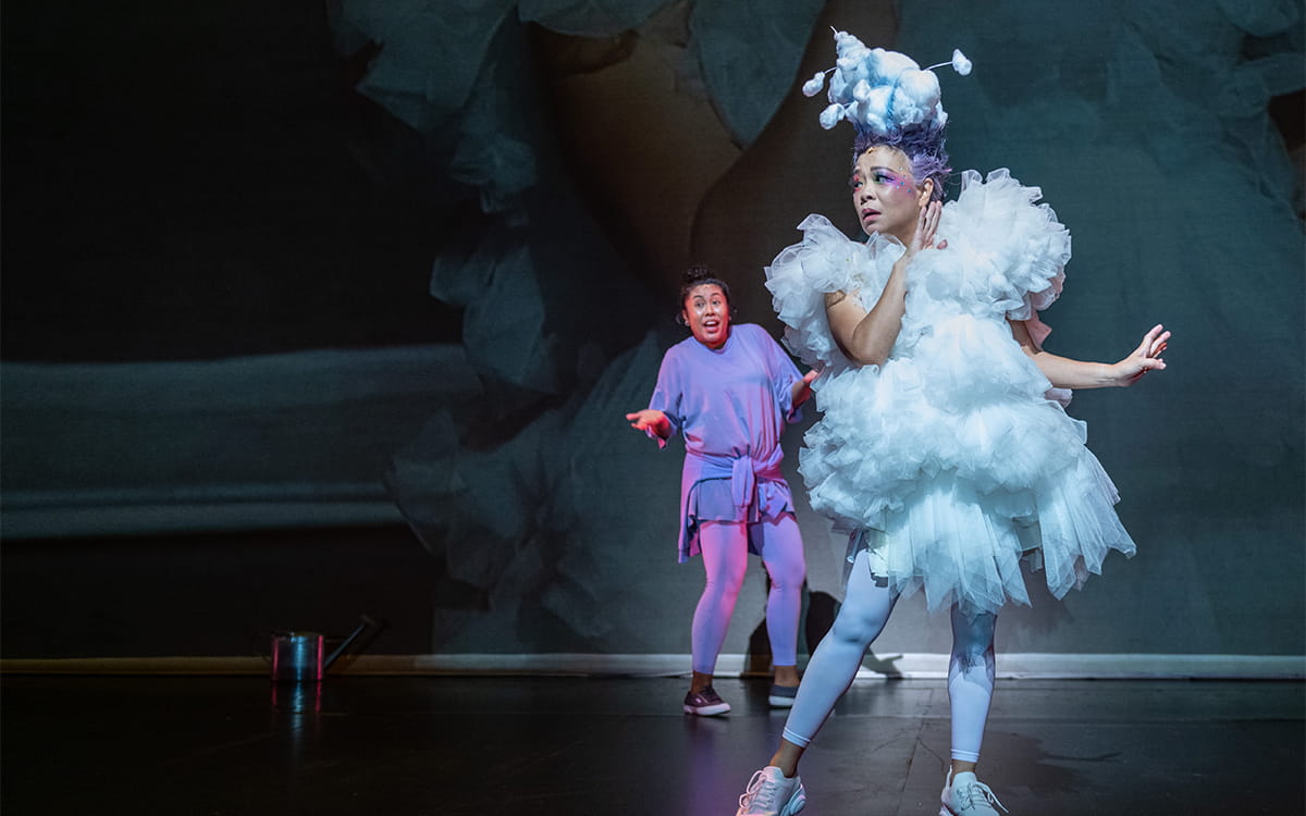 Scene from The Feelings Farm (2021), with an actress dressed as a cloud in the foreground and a young female character in the background.